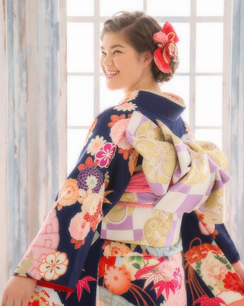 Girl in pink Kimono smiling by window