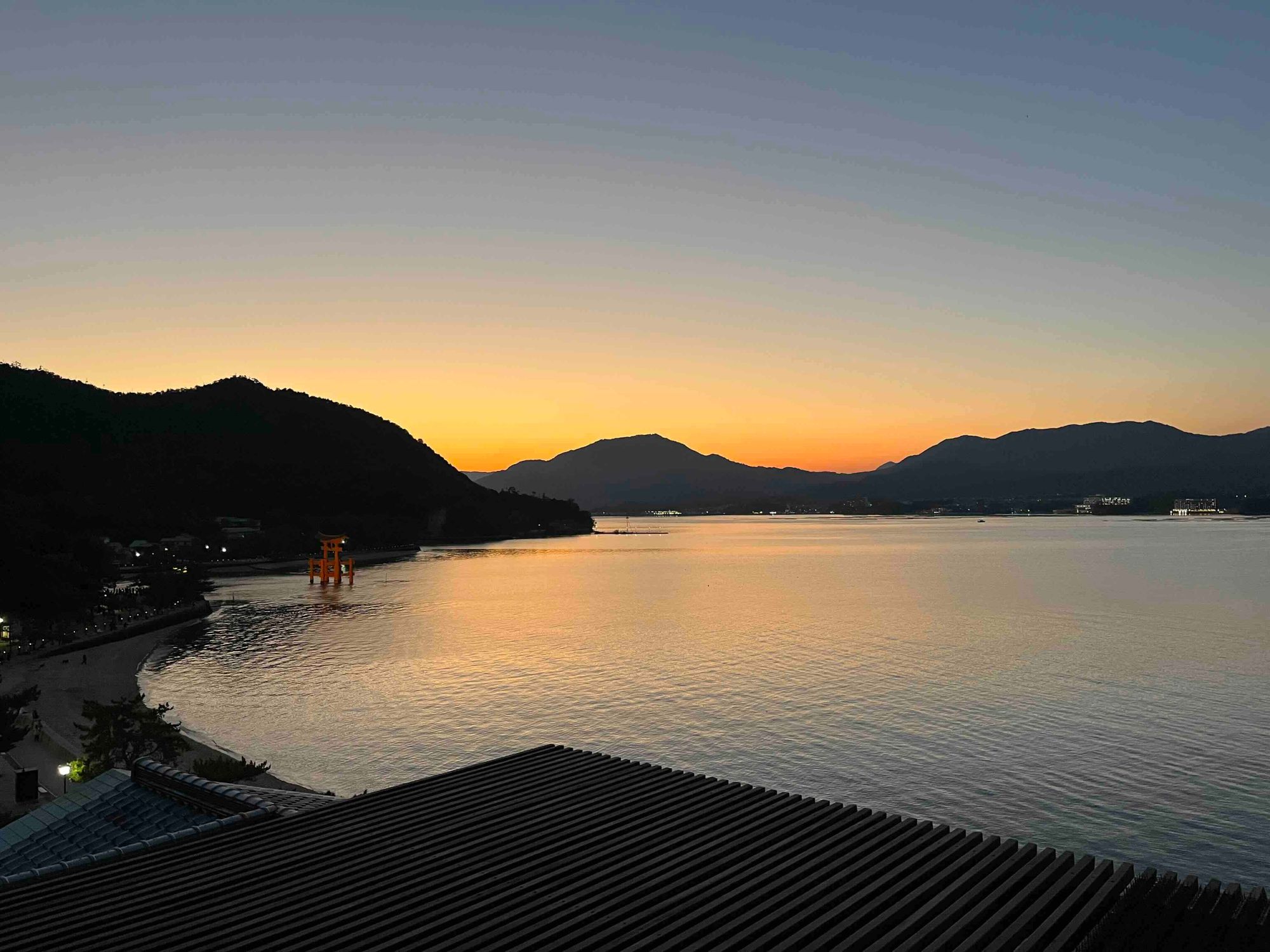 Itsukushima shrine at sunset with water