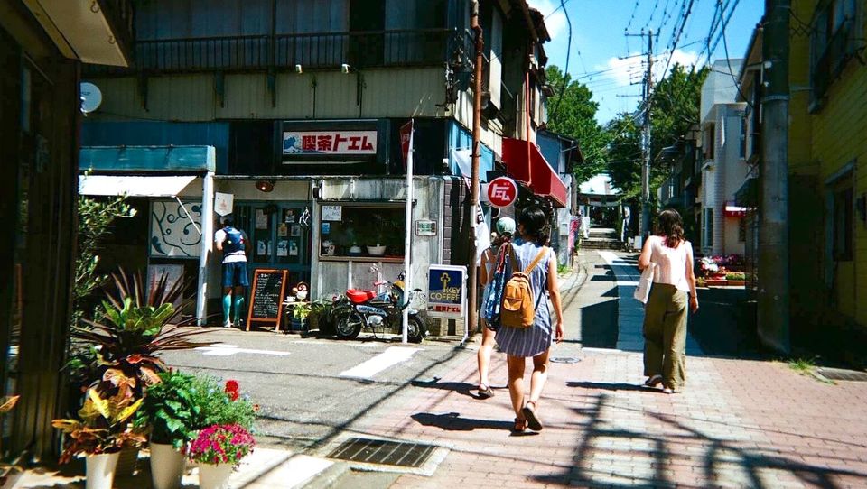 three girls walking in downtown of street in Japan